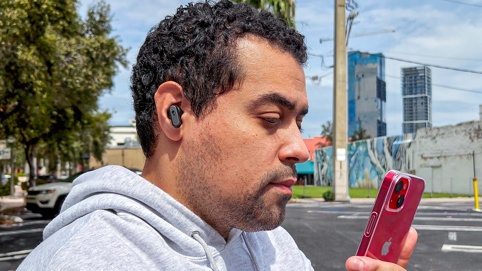 המבקר אלכס בראצ'טי עונד בחוץ אוזניות Skullcandy Dime 3