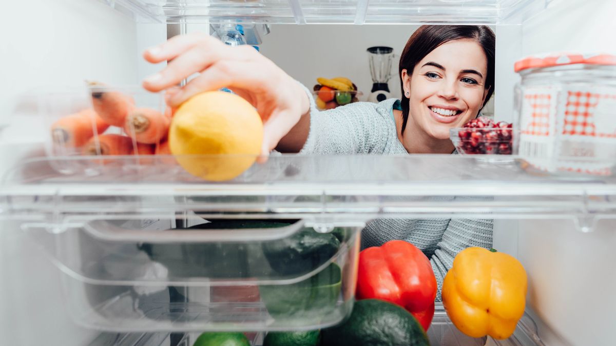 Woman looking inside a fridge