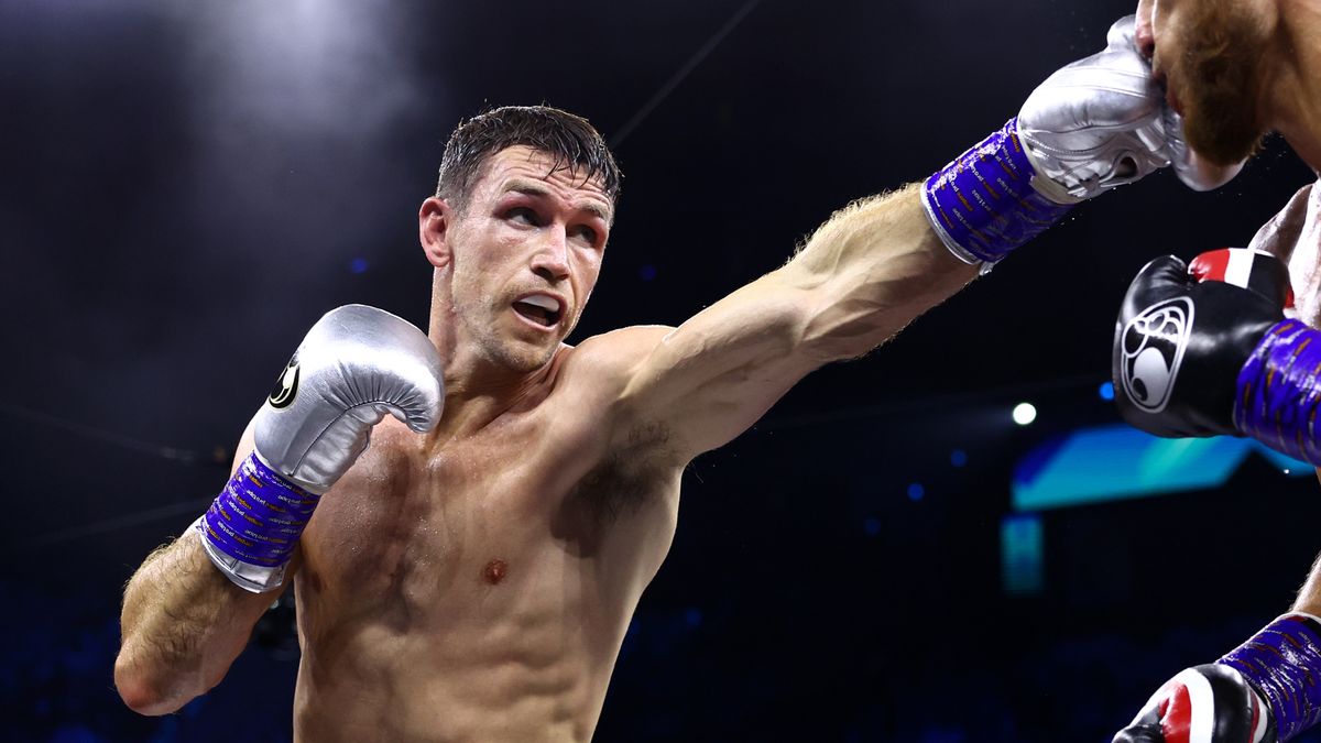 Callum Smith, in red and white shorts and silver boxing gloves, punches an opponent ahead of the Beterbiev vs Smith live stream