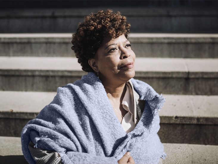 photo of older black woman in blue shawl gazing into the distance