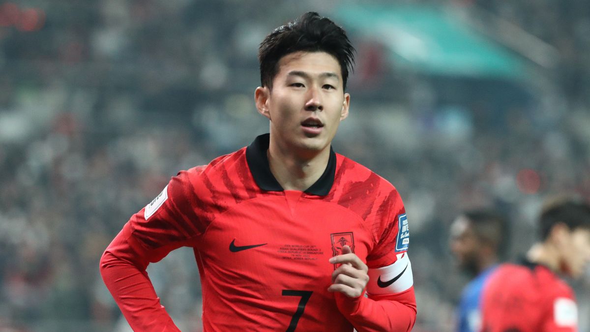 Son Heung-min, wearing a red and black South Korea soccer shirt, warms up for the AFC Asian Cup in Qatar.
