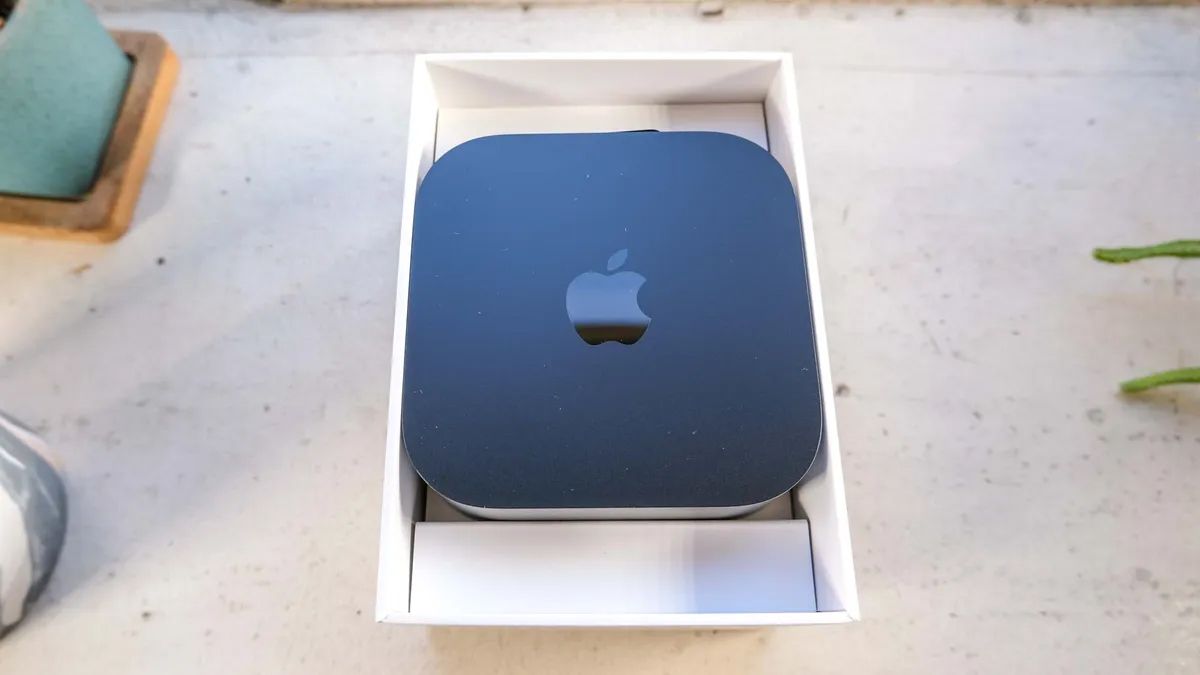 Apple TV 4K sitting on a benchy on a sunny day.