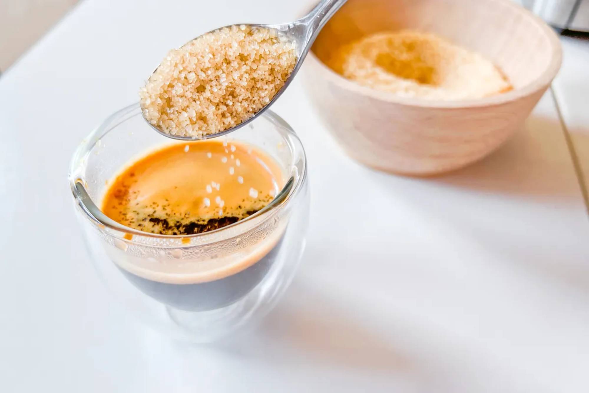 סוכר מוזל לתוך כוס אספרסו 