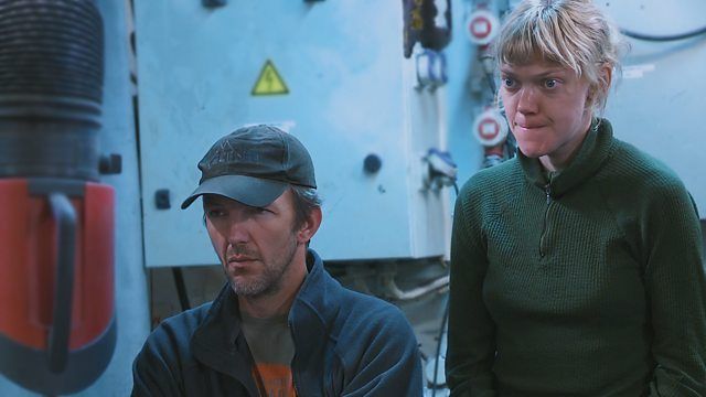 Two Greenpeace activists look sombre aboard the charity