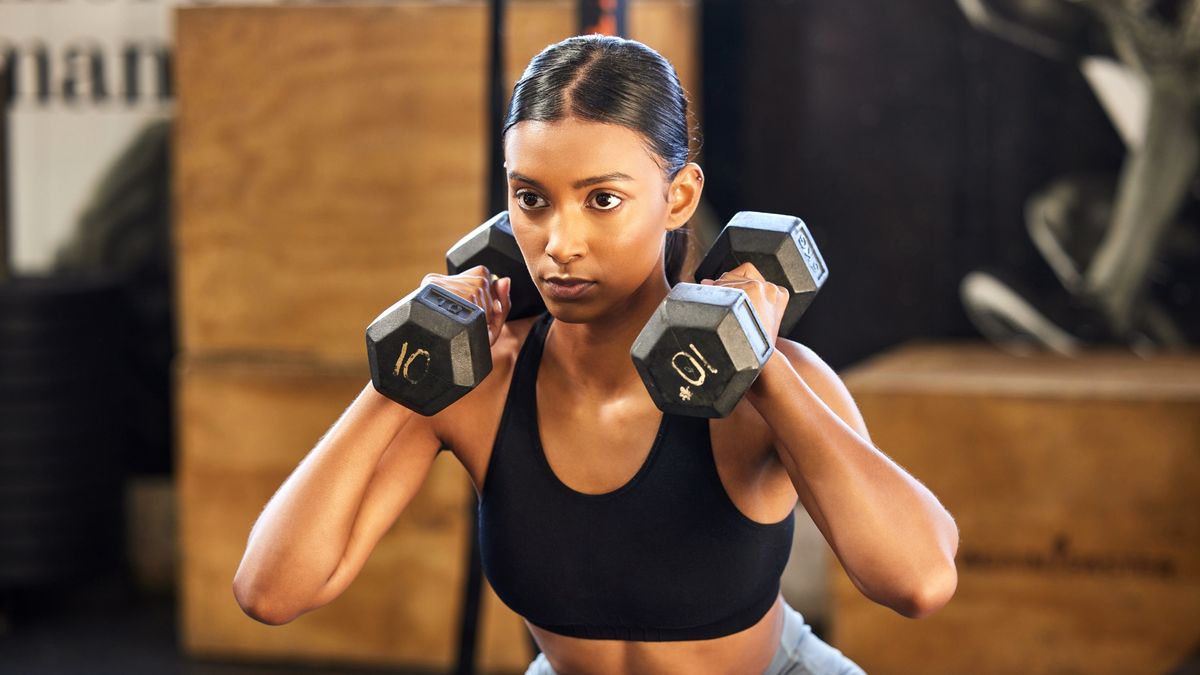 Woman holding two dumbbells