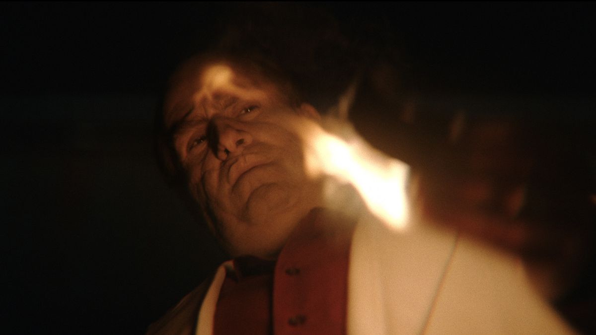 The Penguin (Colin Farrell) holds something burning in Max