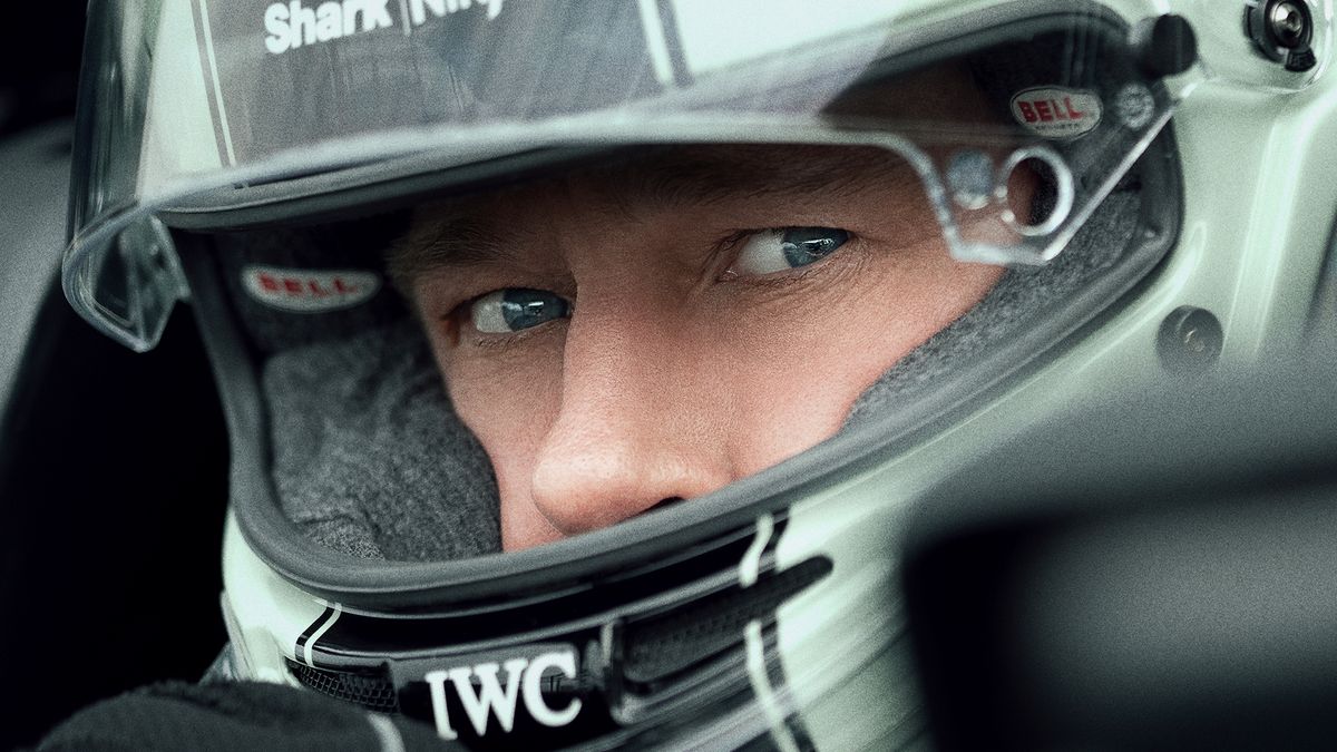 A close-up of Brad Pitt in a racing helmet in Apple