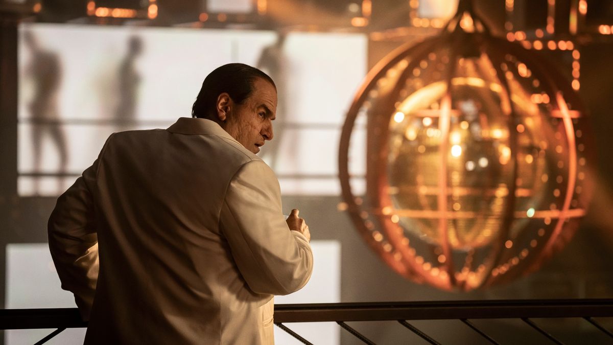 The Penguin (Colin Farrel) looking over his shoulder in a white jacket in the HBO show,