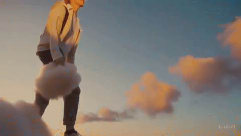 An AI video from Tammy Lovin using OpenAI showing a young man walking on clouds