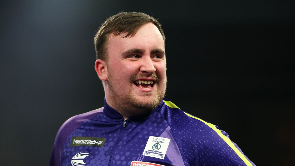 Luke Littler of England smiles at the oche ahead of the World Matchplay Darts live stream 2024