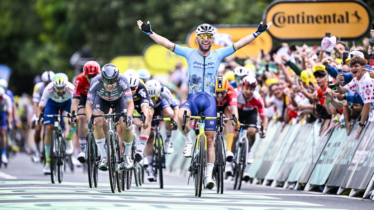 Mark Cavendish, in Astana Qazaqstan blue, crosses the line in first at the 2024 Tour de France.