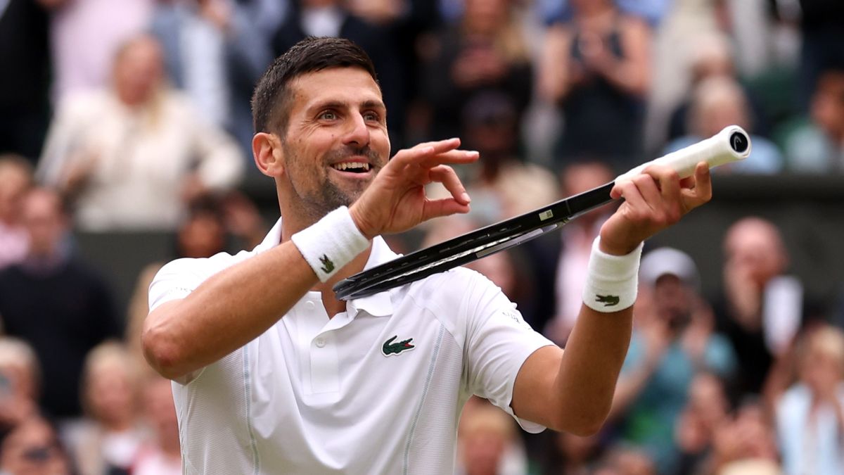 Novak Djokovic of Serbia mimes playing his tennis racquet like a violin to antagonize the All England Club crowd ahead of the Alcaraz vs Djokovic Wimbledon final 2024
