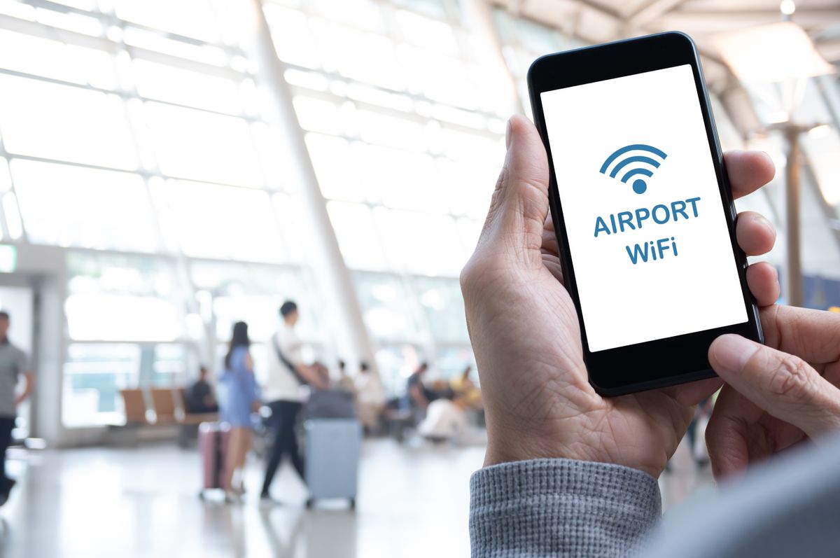 person on Airport free Wi-Fi using a phone