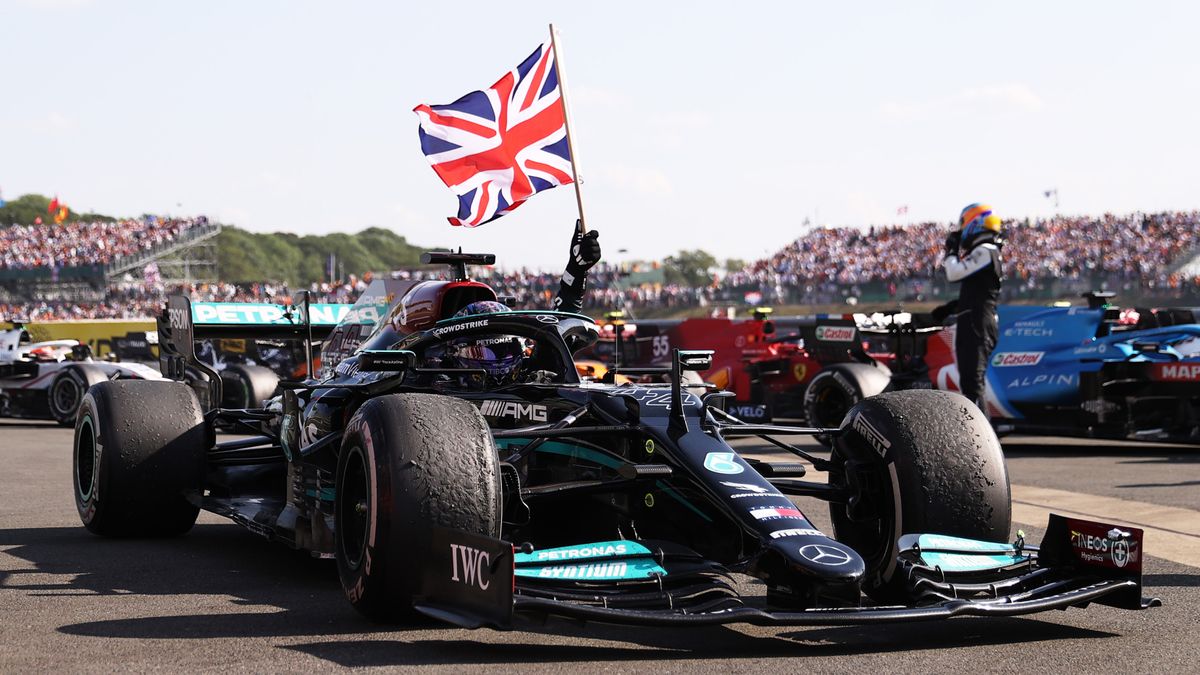Race winner Lewis Hamilton of Great Britain and Mercedes AMG F1 celebrates by flying the Union Jack flag from his race car