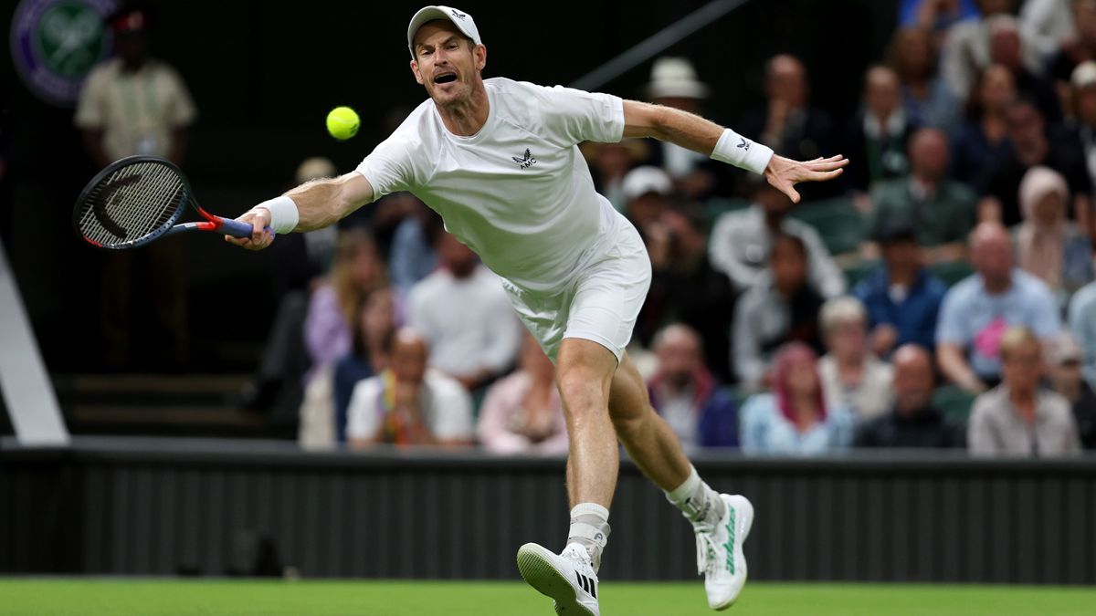 Andy Murray stretches for a forehand at Wimbledon 2024.