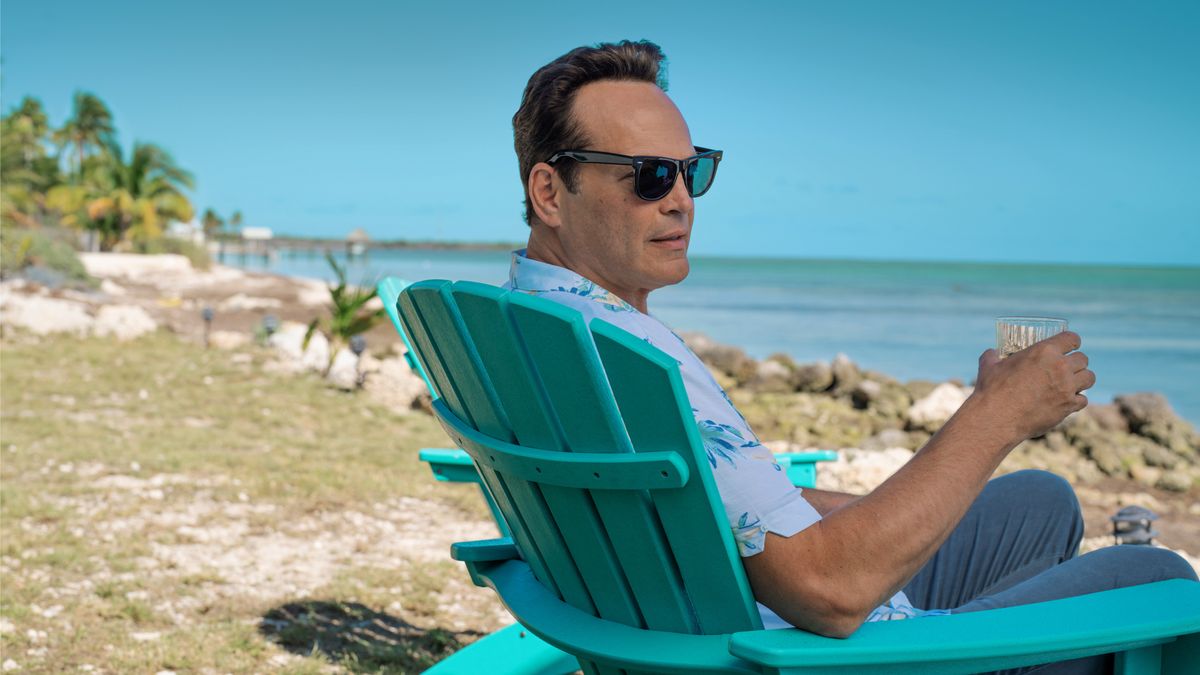 Andrew Yancy (Vince Vaughn) sits on a blue deck chair at the beach in Apple TV Plus