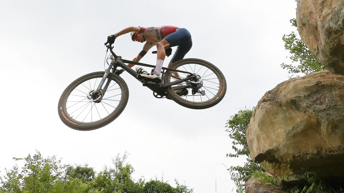 Thomas Pidcock of Team Great Britain jumps off a boulder ahead of the Mountain Bike World Championships 2024 live stream