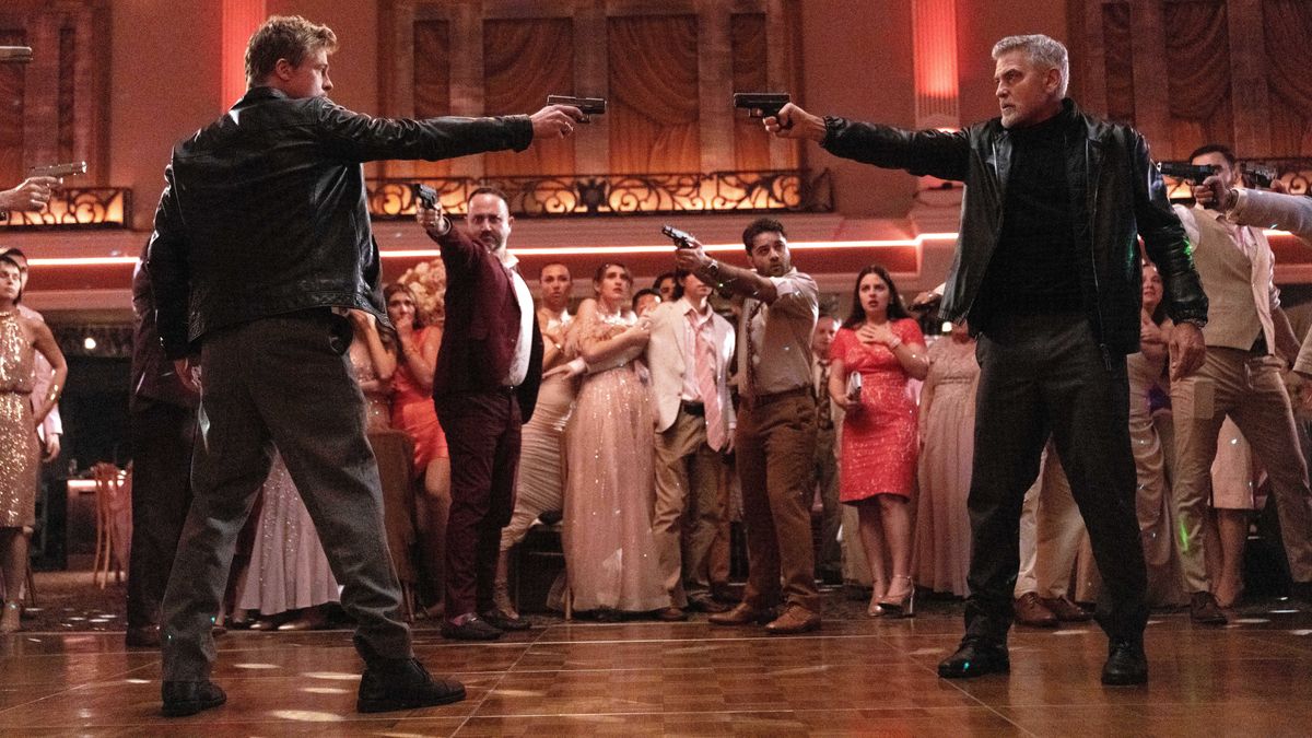 Brad Pitt and George Clooney level guns at one another in a ballroom "Wolfs"