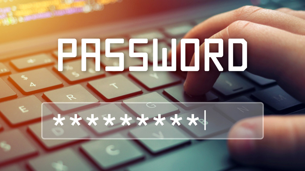 יד מקלידת על מקלדת מחשב נייד בעוד המילה PASSWORD ושדה התחברות מוצבות מעל.