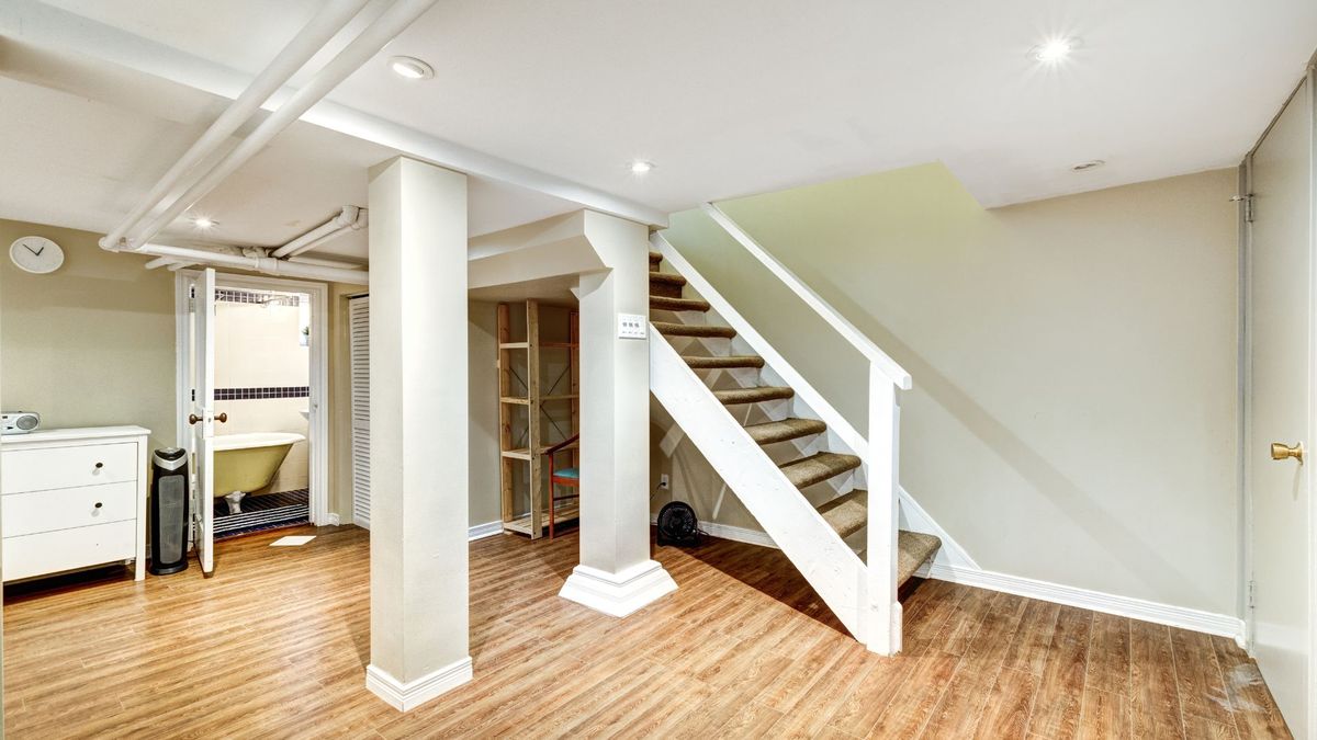 A brightly lit basement with stairs leading into it