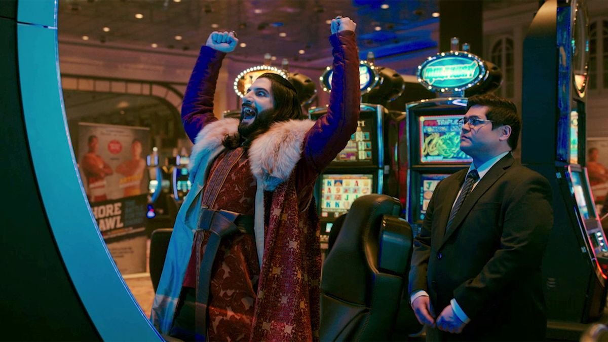 Kayvan Novak as Nandor the Relentless and Harvey Guillén as Guillermo de la Cruz at a casino in What We Do In The Shadows