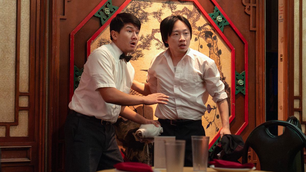 Ronny Cheng and Jimmy O. Yang (L-R) standing in a restaurant in Hulu's "Interior Chinatown"