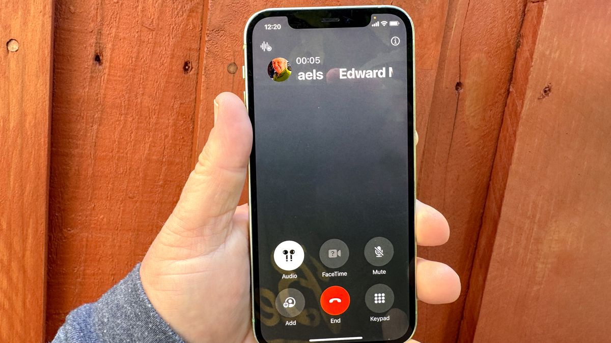 A phone call on an iphone 12, running iOS 18.1, with the call record feature available