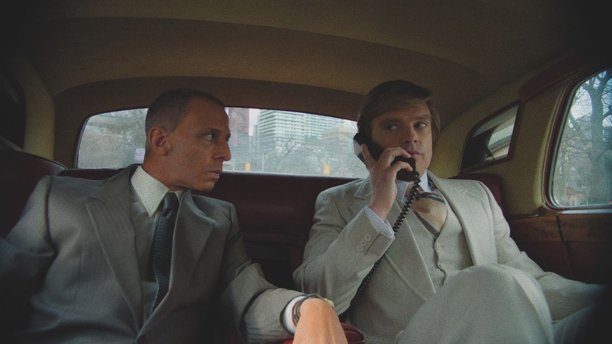 Roy Cohn (Jeremy Strong) and Donald Trump (Sebastian Stan) (L-R) in a car in "The Apprentice" movie