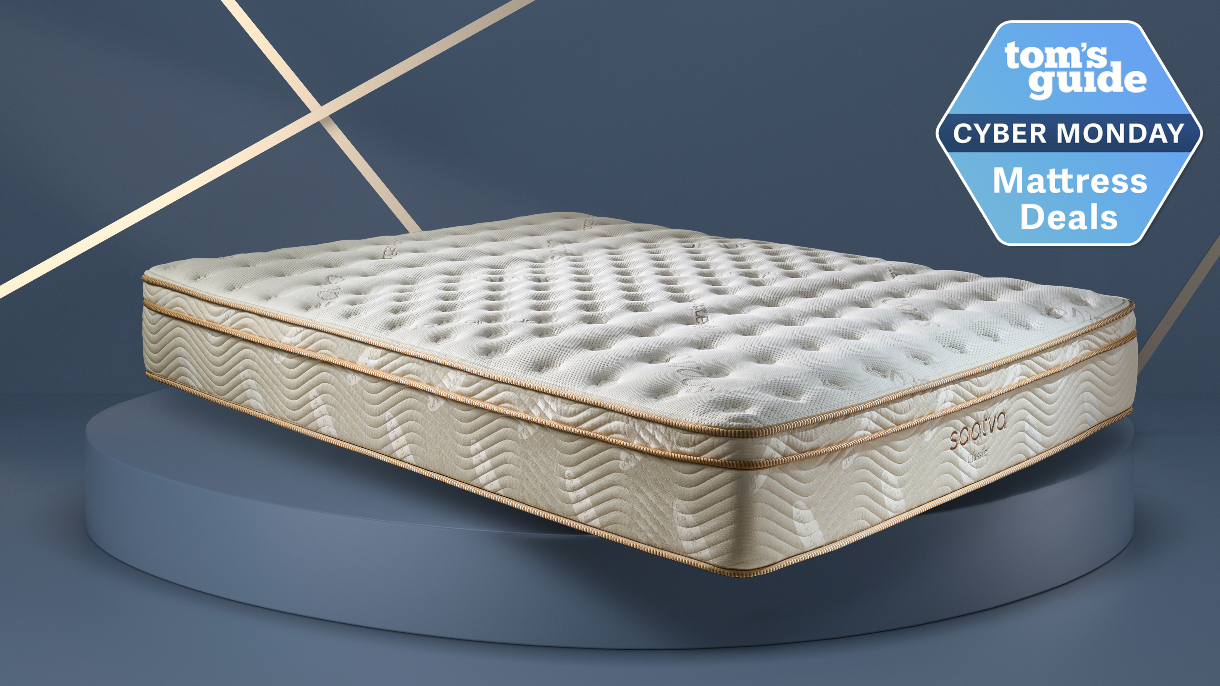 התמונה מציגה את מזרן Saatva Classic על רקע כחול-אפור עם תג מכירה של מזרן Cyber ​​Monday בפינה הימנית העליונה