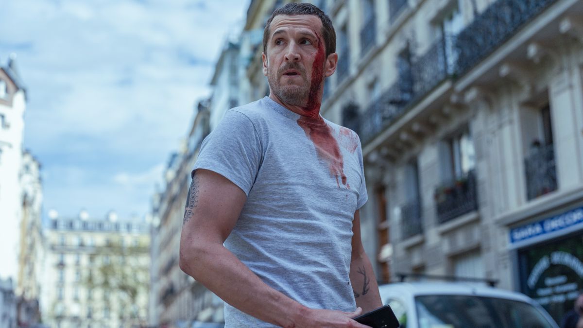 A bloody Franck Lazareff (Guillaume Canet) in a white t shirt in Netflix's "Ad Vitam"