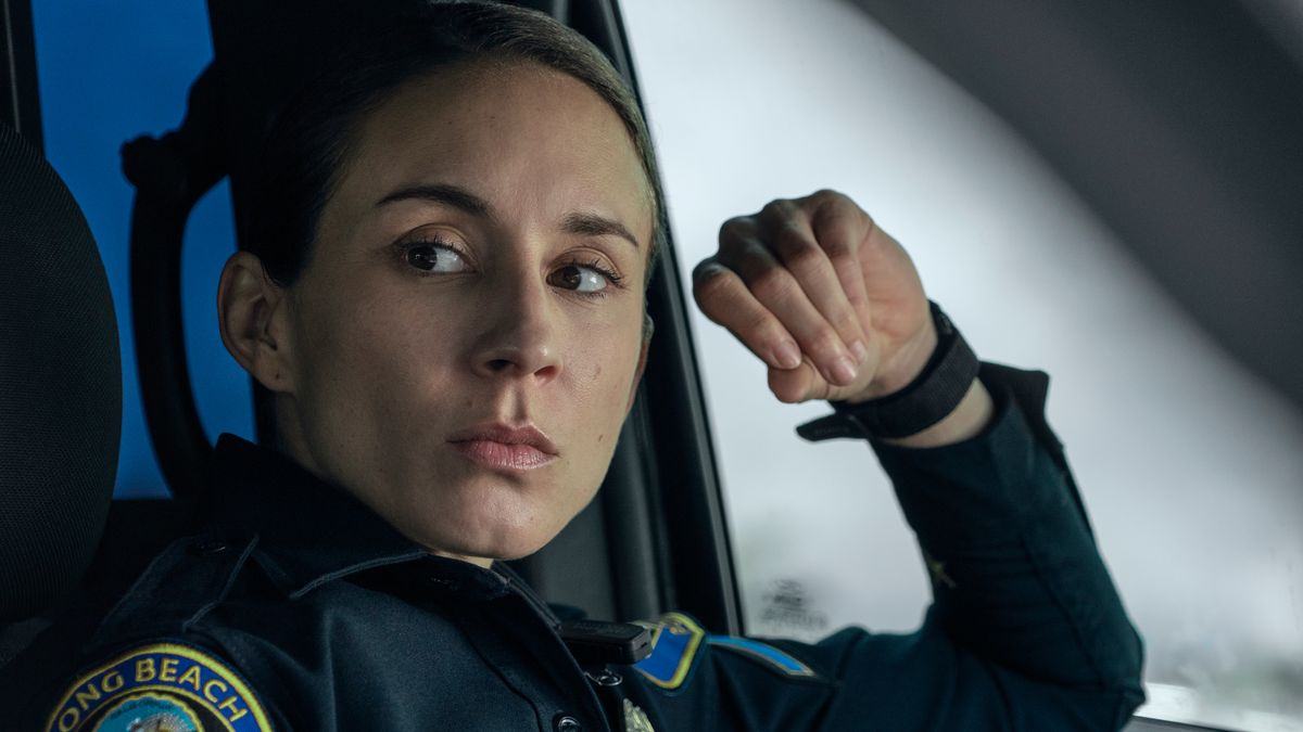 Traci Harmon (Troian Bellisario) sitting inside a cop car in Prime Video's "On Call"