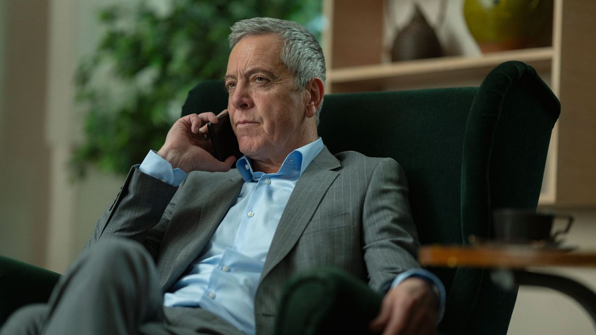 Calligan (James Nesbitt) sitting down and taking a phone call in Netflix's "Missing You"