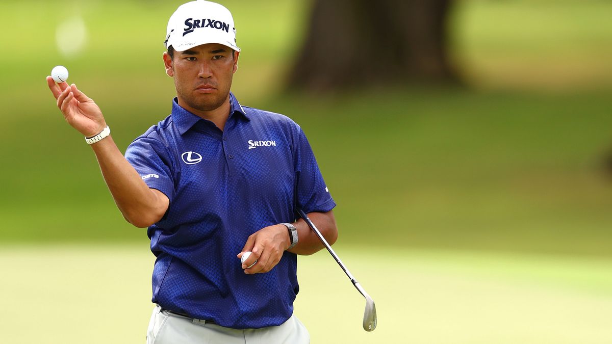 Hideki Matsuyama holds a golf ball on the fairway ahead of the Sony Open 2025 PGA tournament airing live online and on TV around the world.