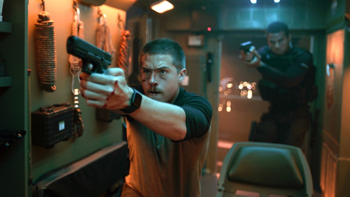 Eric (Dylan Sprouse) (front) and Romeo (Mason Gooding) holding pistols in "Aftermath"