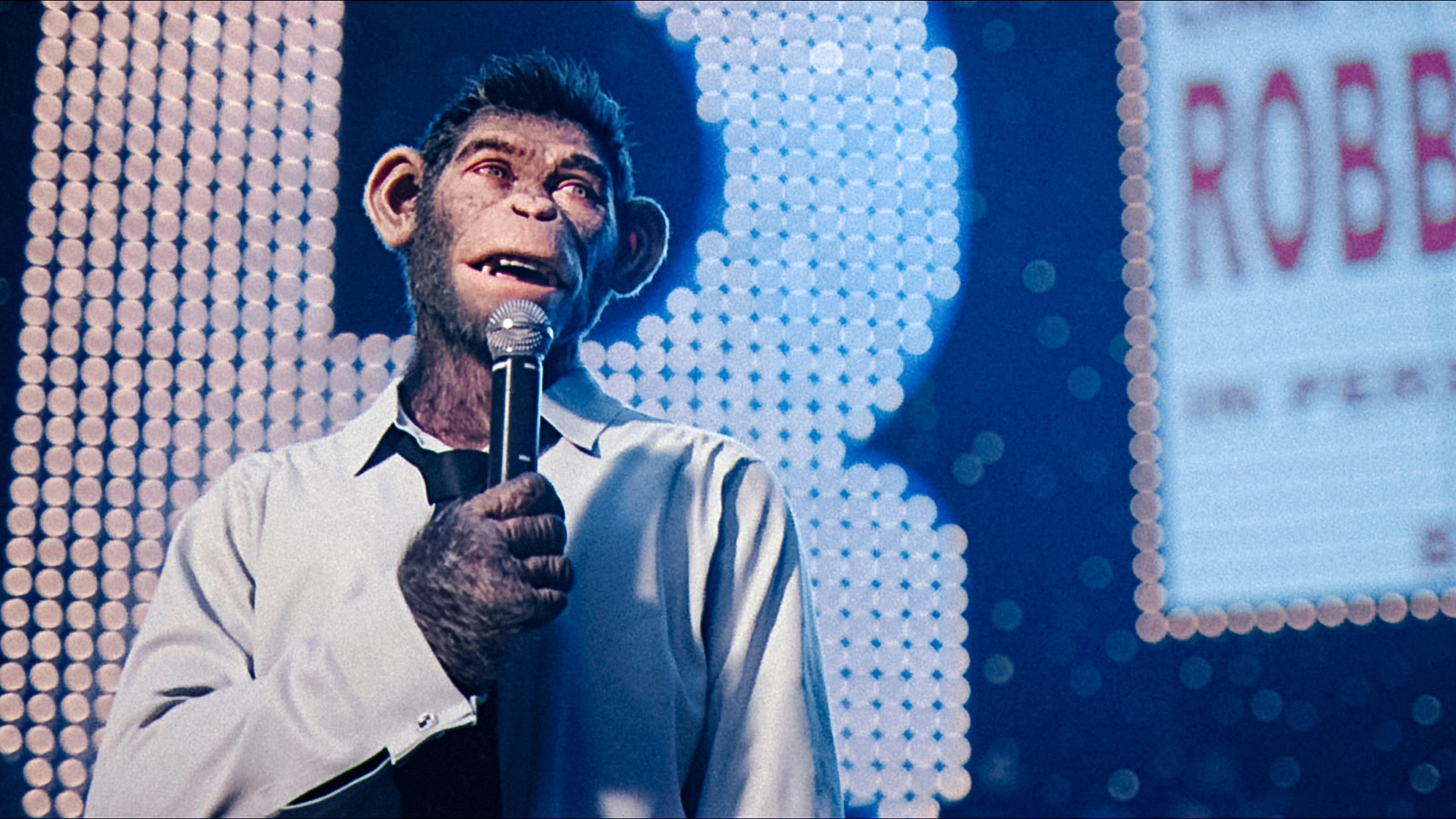 CG-Animated Chimpanzee Robbie Williams on Stage במהלך קונצרט אצל מייקל גרייסי "איש טוב יותר"ו
