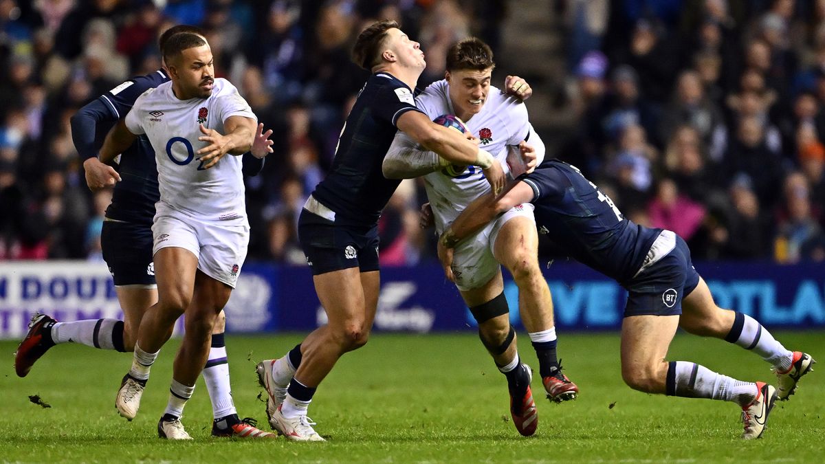 Tommy Freeman of England takes on Huw Jones and Kyle Styen of Scotland during Scotland vs England in the Guinness Six Nations 2024
