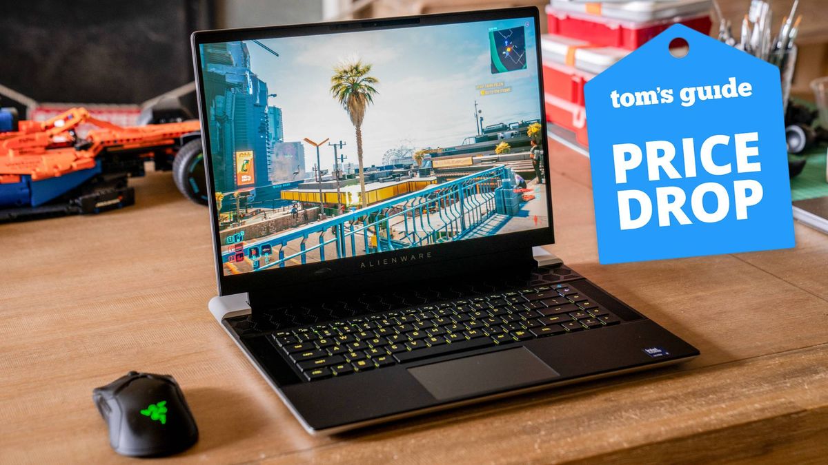 Alienware x16 R2 with Razer gaming mouse on table with Tom's Guide Price Drop badge