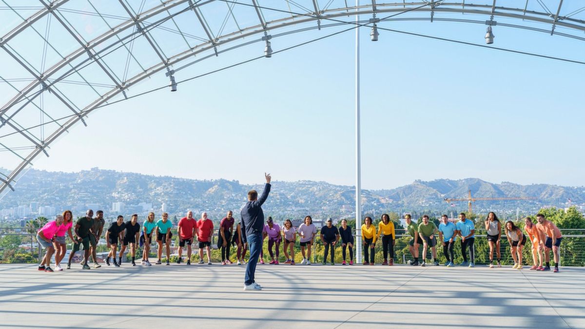 The 2025 contestants wait on the start line as host Phil Keoghan prepares to start "The Amazing Race" season 37