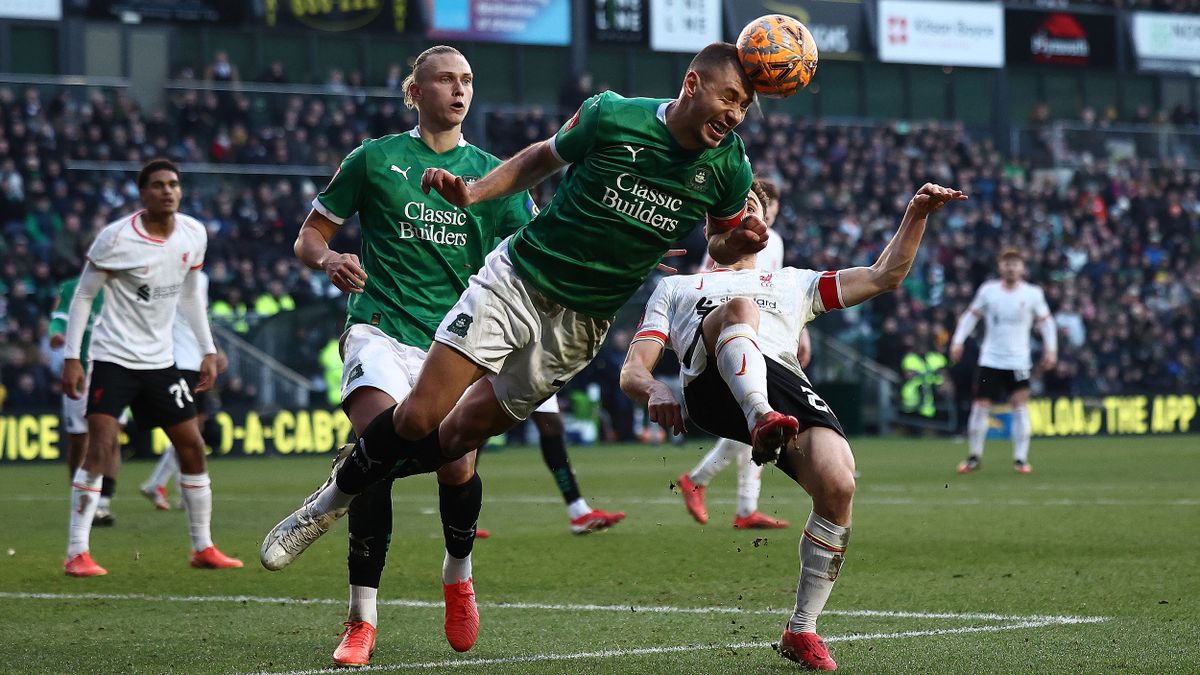 Plymouth Argyle player heads the ball on the way to the team's FA Cup victory over Liverpool