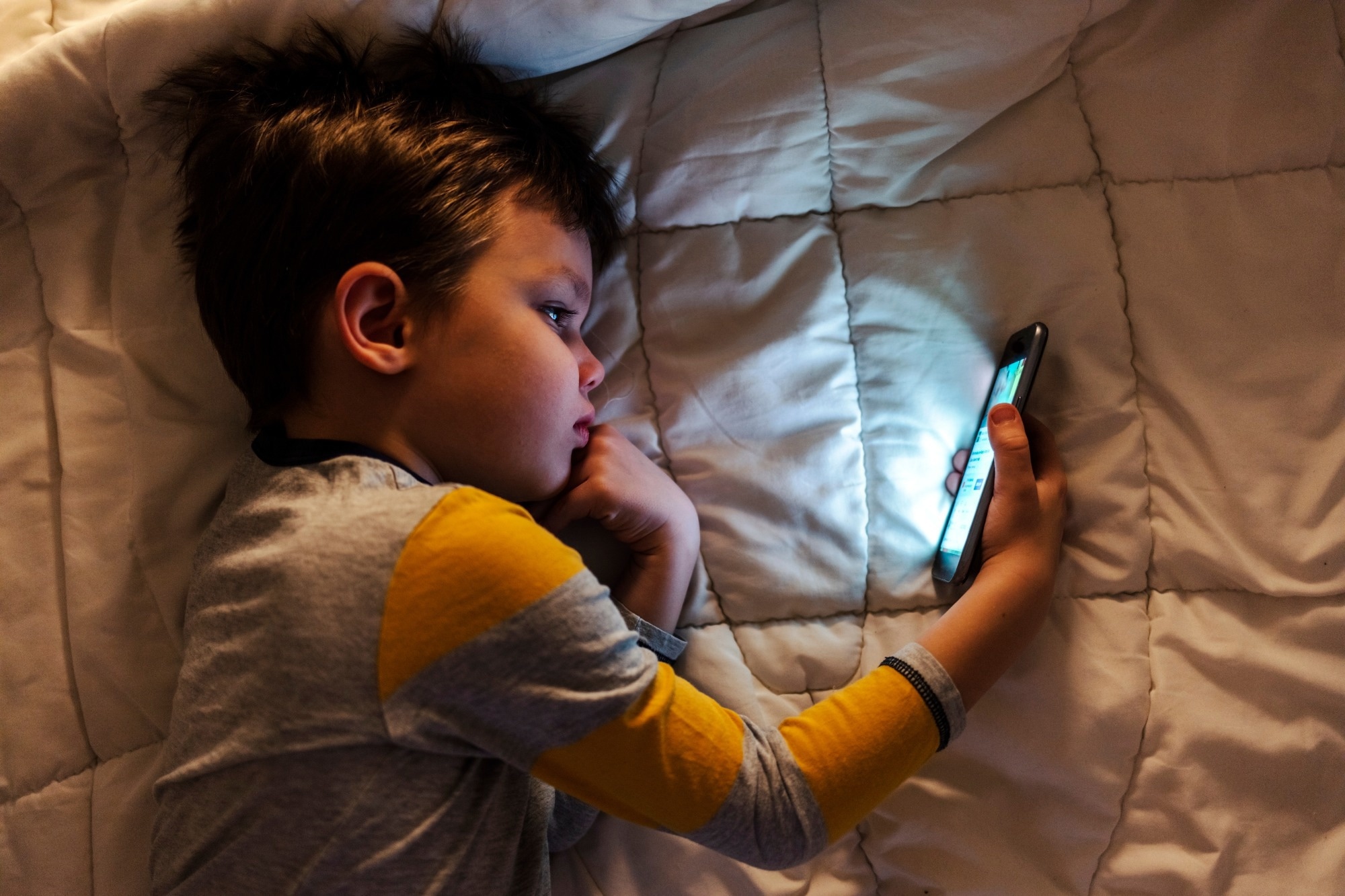 Cute little boy using a smartphone.
