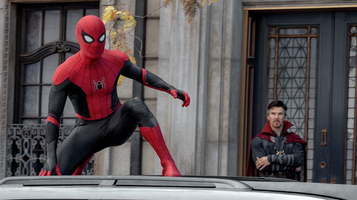 Spider-Man (Tom Holland) crouches on top of a car in a scene from "Spider-Man: No Way Home"