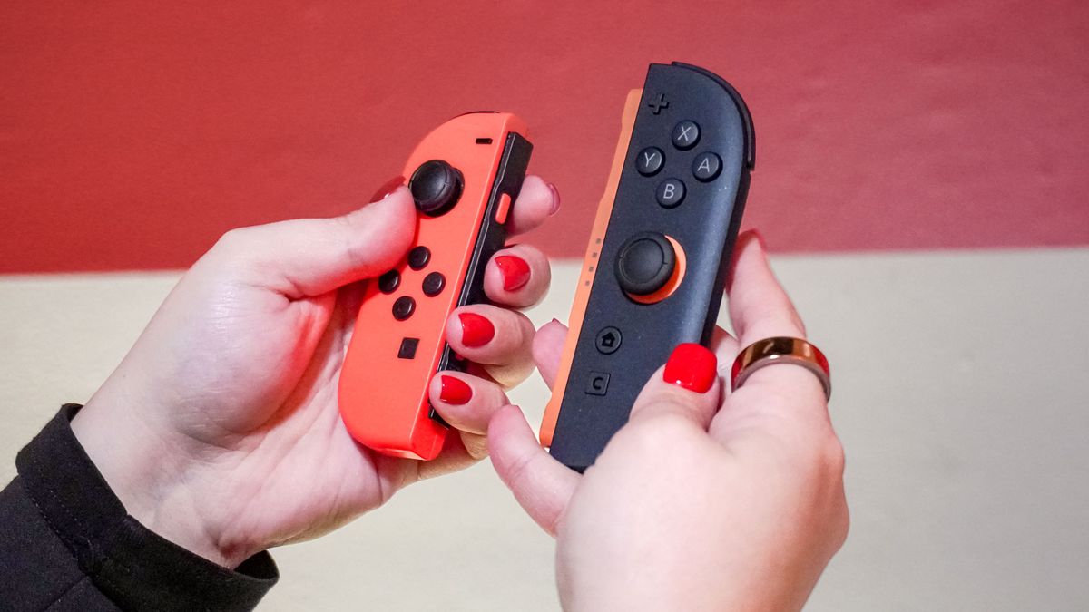 A Joy-Con in one hand and a Joy-Con 2 in the other