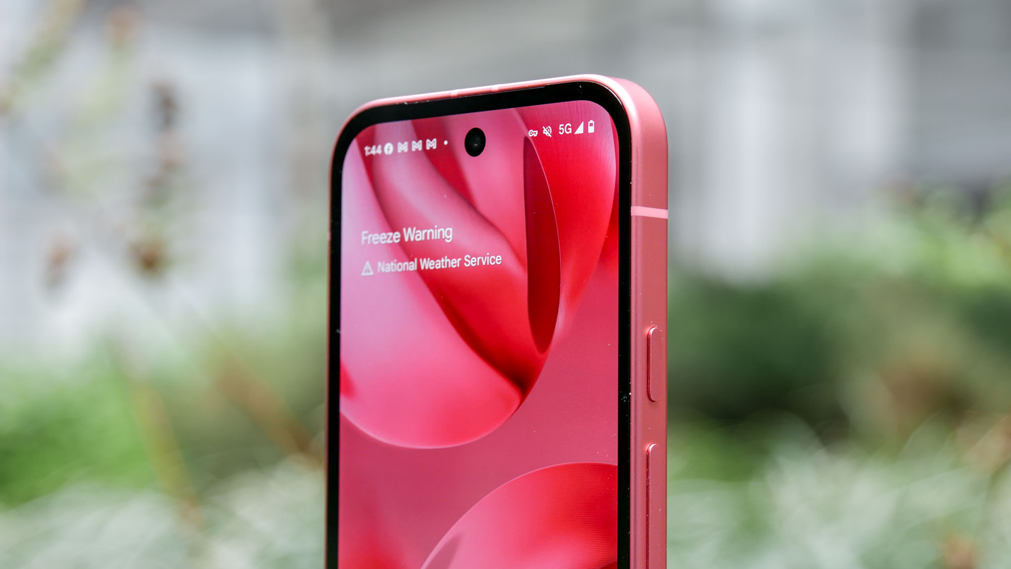 Google Pixel 9a held in the hand.