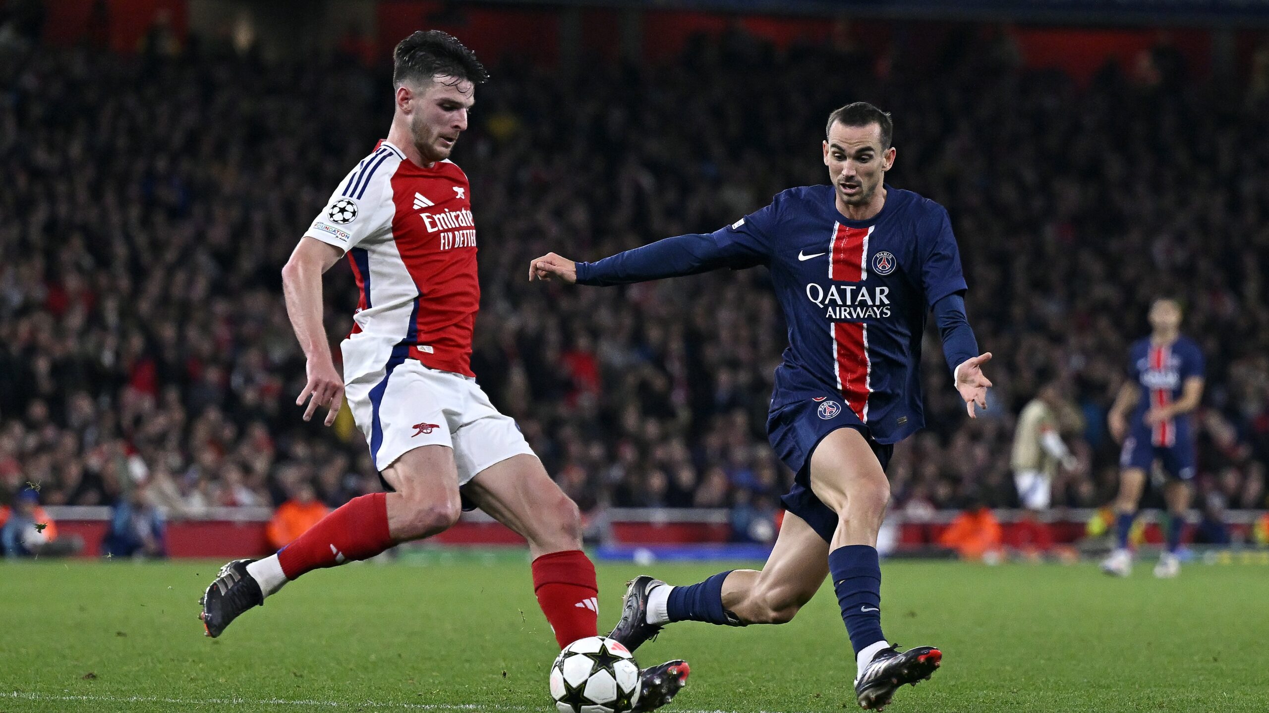 Fabian Ruiz of Paris Saint-Germain battles for possession during the UEFA Champions League 2024/25 match Arsenal vs Paris Saint-Germain