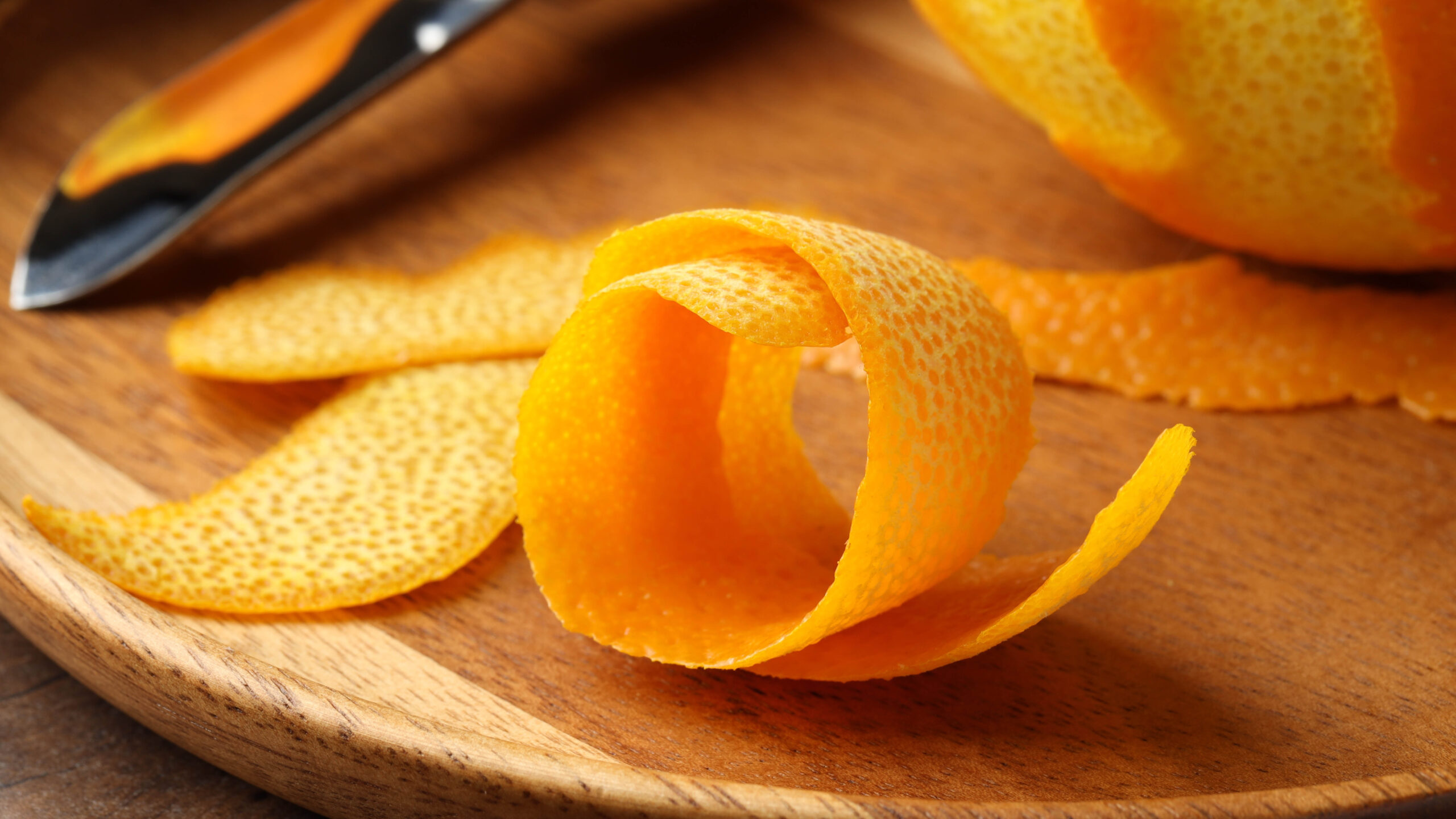 Orange peels on wooden cutting board
