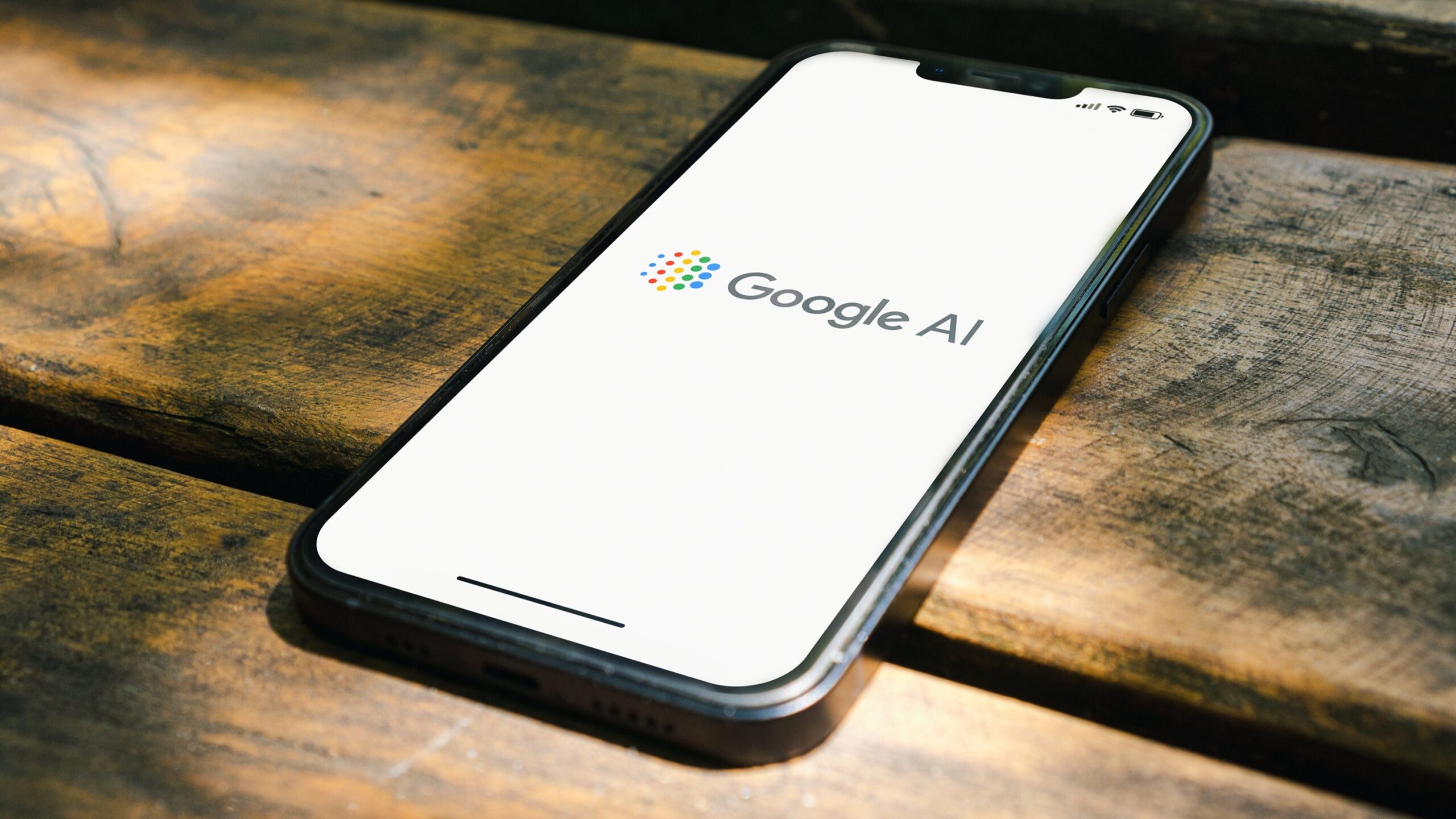 The Google AI logo on a smartphone on a table