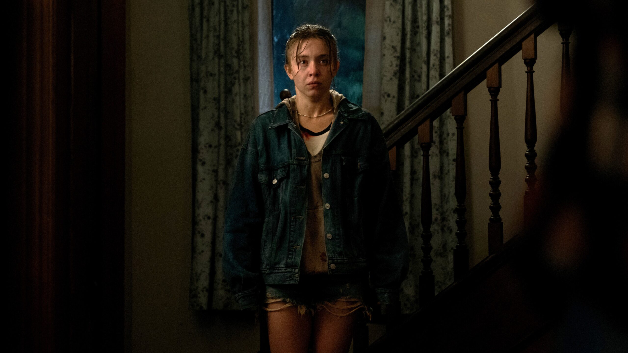 Claire (Sydney Sweeney) stands in wet clothes in a hallway in a scene from Apple TV Plus' "Echo Valley"