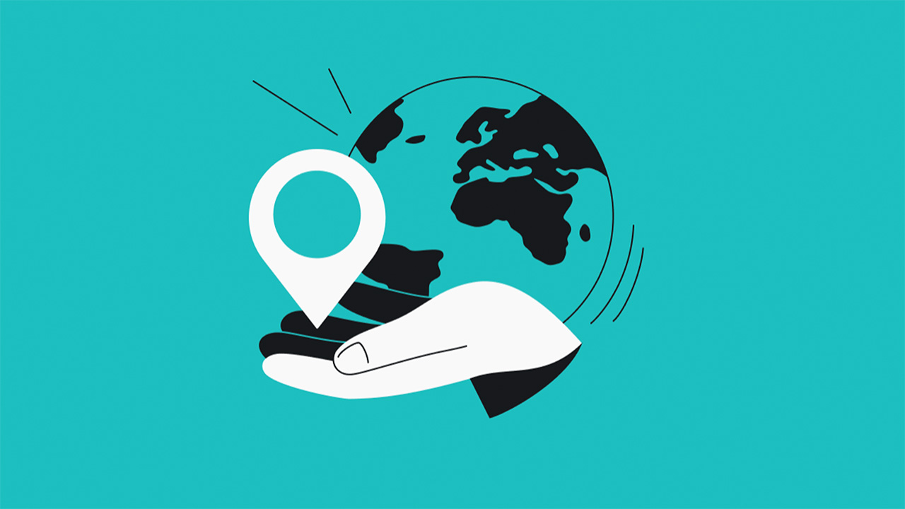 Blue graphic of the globe, with a white cartoon hand holding a map pin
