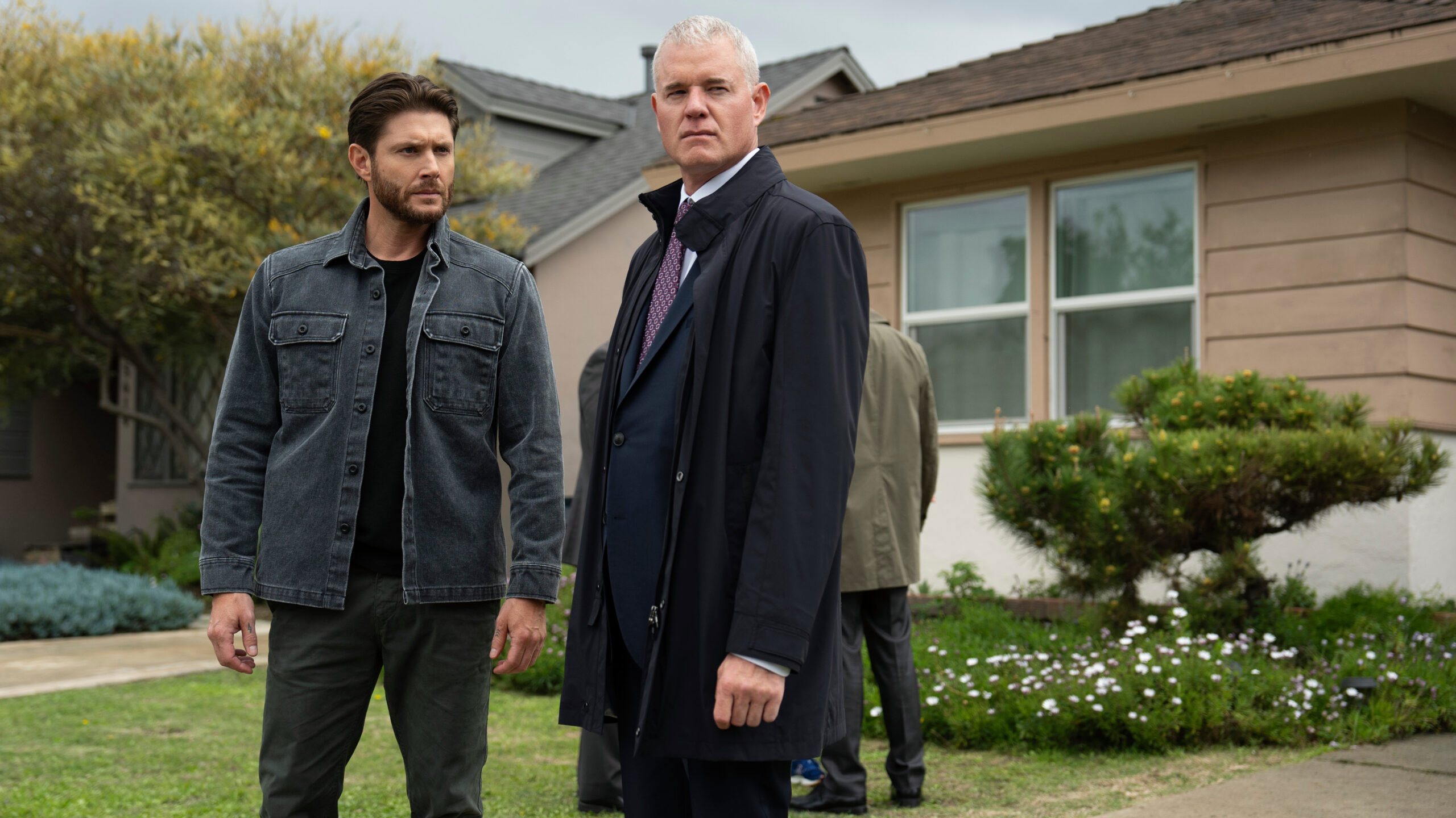 Mark Meachum (Jensen Ackles, left) and Nathan Blythe (Eric Dane) standing side-by-side outside a house in a scene from Prime Video's "Countdown"