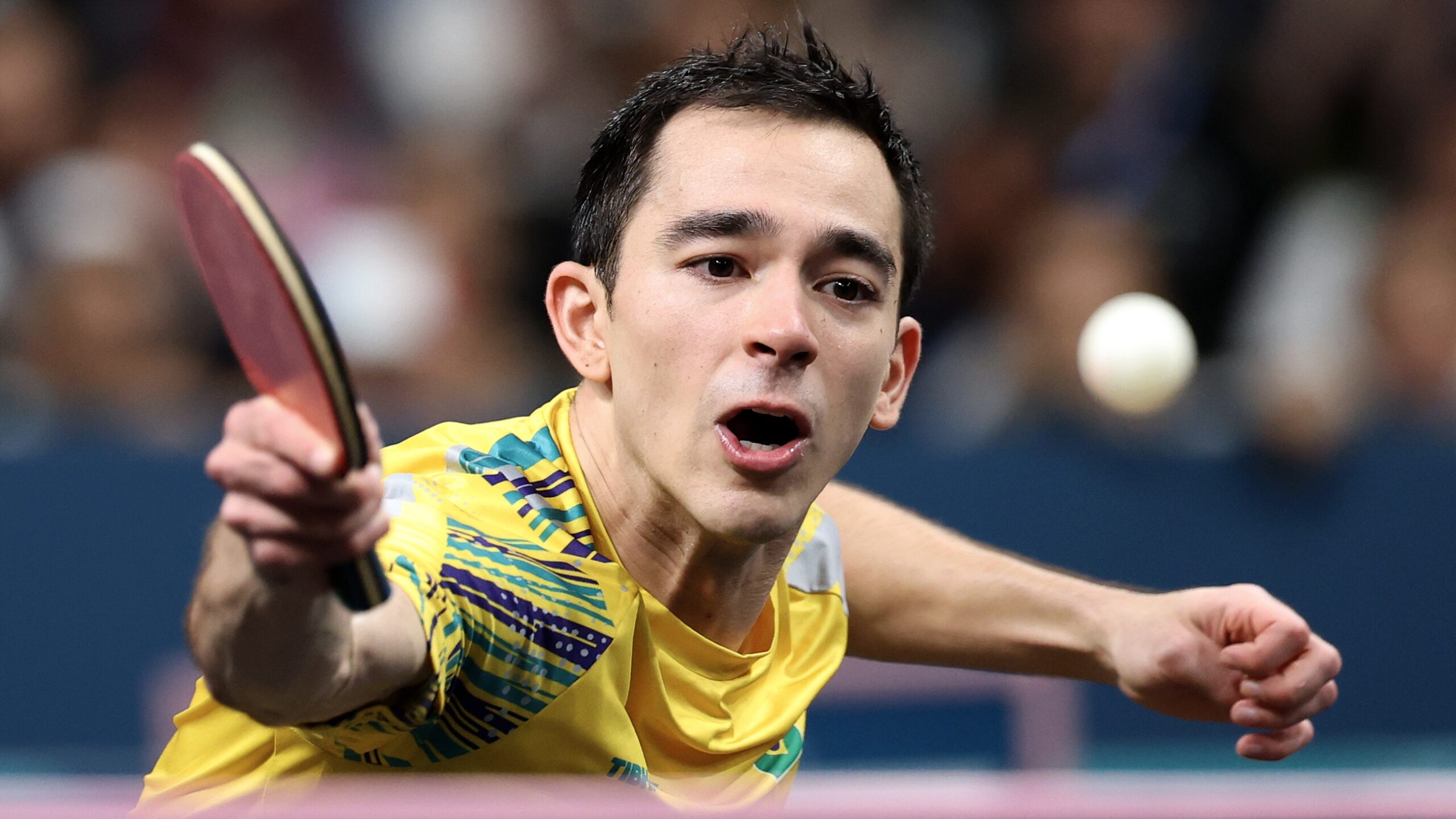 Hugo Calderano of Team Brazil, wearing yellow and green shirt, competes in the ITTF World Table Tennis Championships Finals 2025